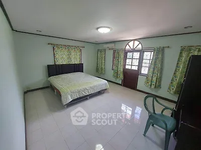 Spacious bedroom with natural light and tiled flooring