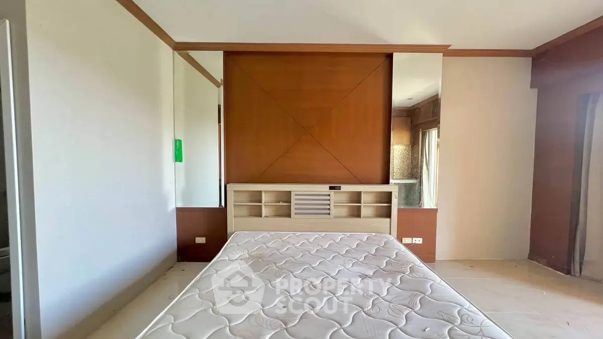 Spacious bedroom with modern design and built-in storage, perfect for comfortable living.
