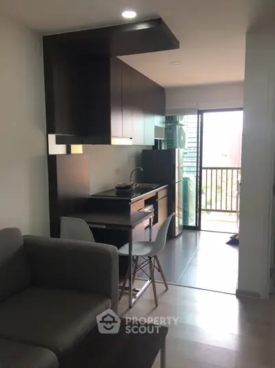 Modern open-layout kitchen with balcony view in stylish apartment