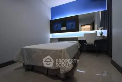 Modern minimalist bedroom with sleek design and ambient lighting