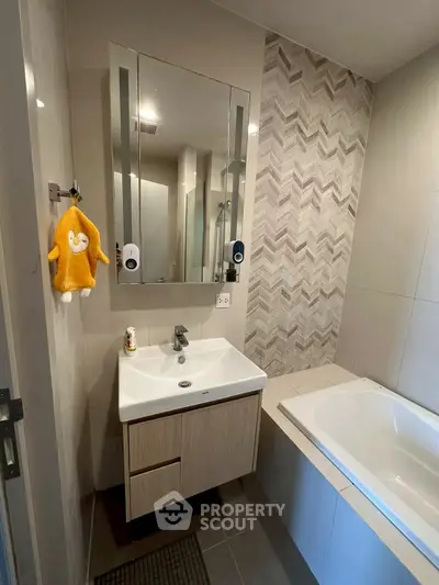 Modern bathroom with stylish vanity and bathtub in contemporary apartment