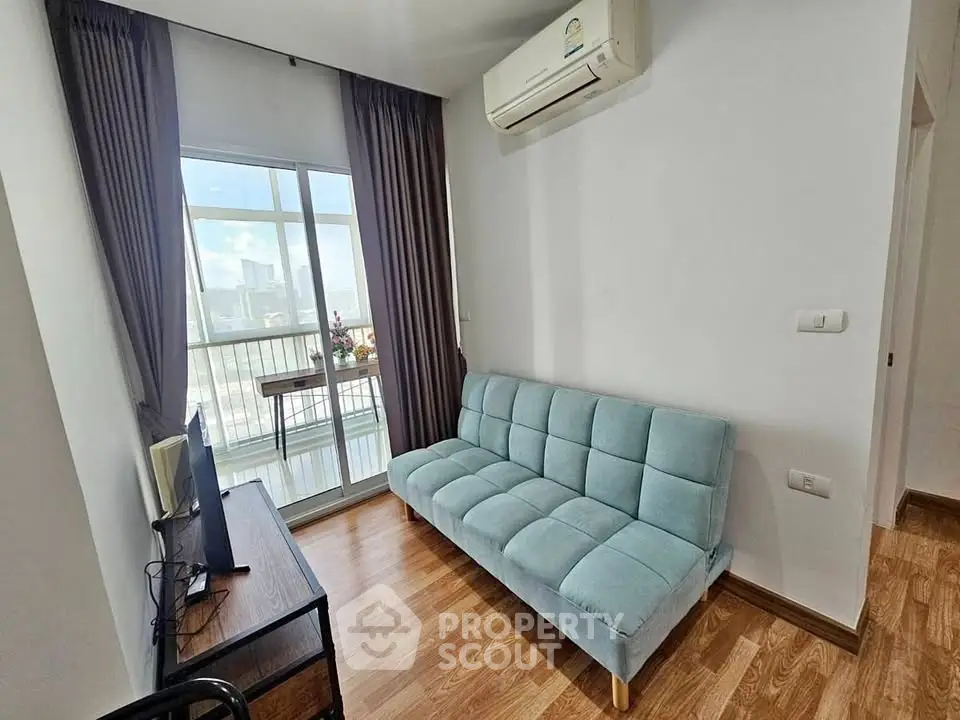 Cozy living room with modern sofa and city view balcony in stylish apartment.