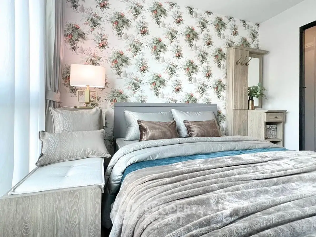 Luxurious bedroom with floral wallpaper and plush bedding in modern apartment