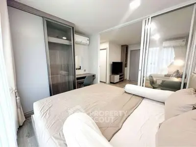 Modern bedroom with mirrored closet and cozy decor