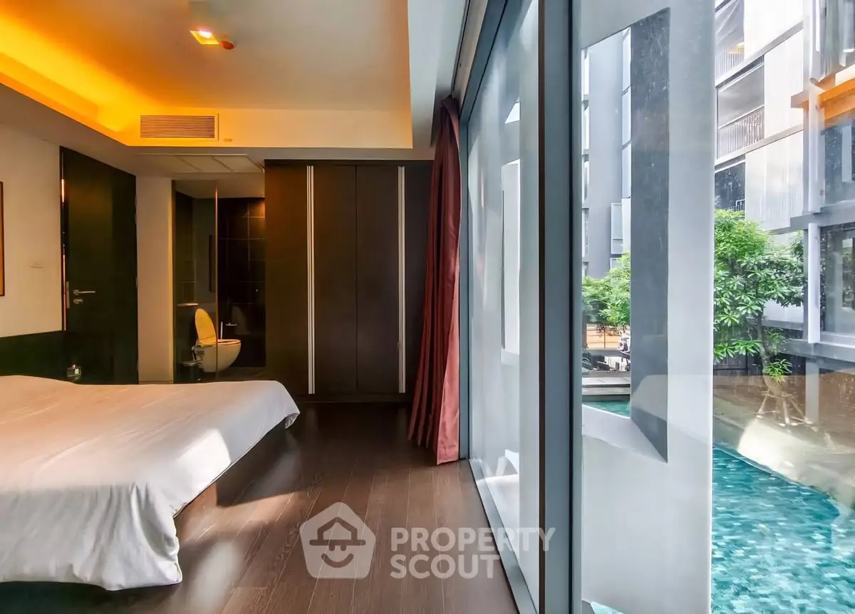 Luxurious bedroom with pool view and modern design