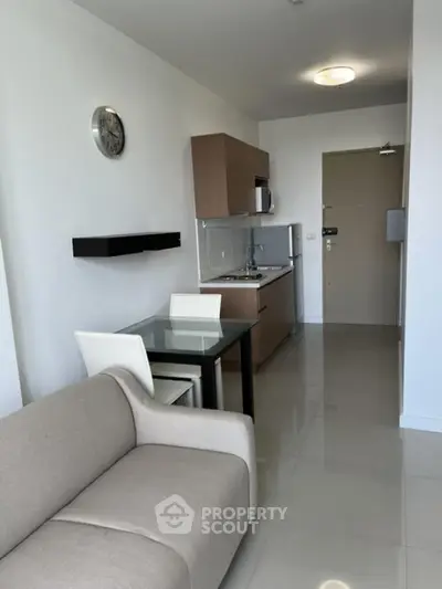 Modern compact living room with kitchenette and stylish decor