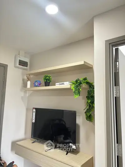 Modern living room with sleek TV setup and stylish shelving