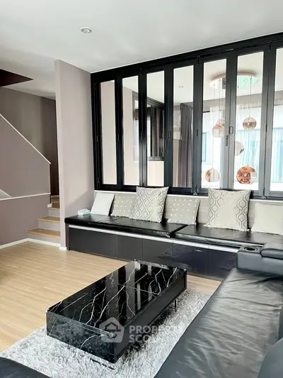 Modern living room with sleek black furniture and stylish decor