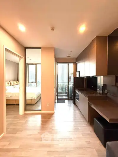 Modern apartment interior with open kitchen and cozy bedroom view