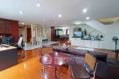 Spacious open-plan living room with modern furniture and wooden flooring