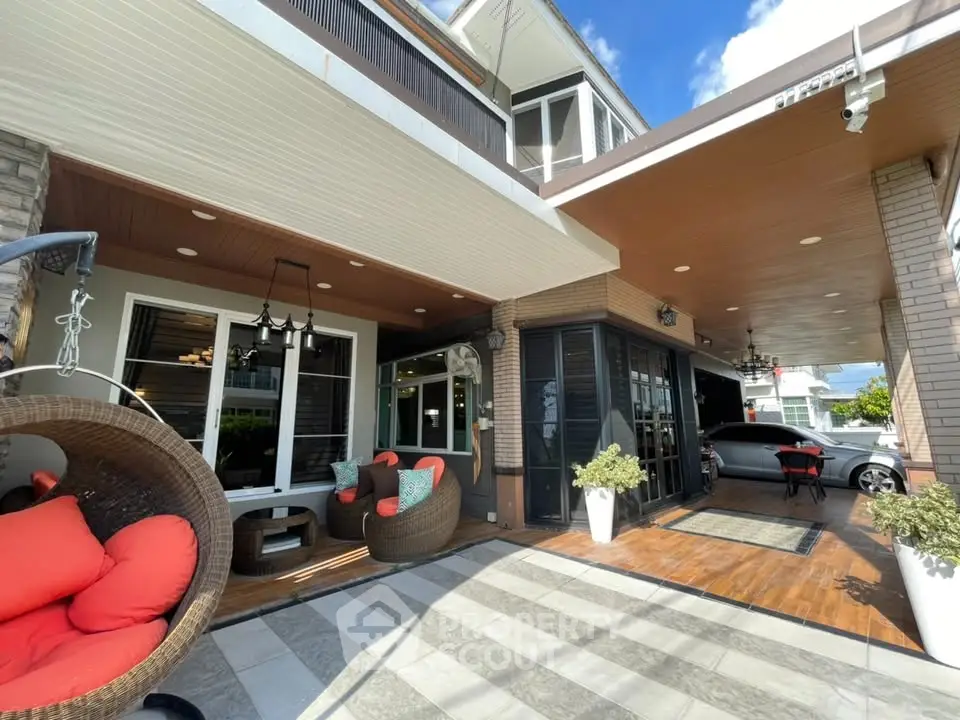 Stunning modern home exterior with stylish patio and hanging chairs, perfect for outdoor relaxation.