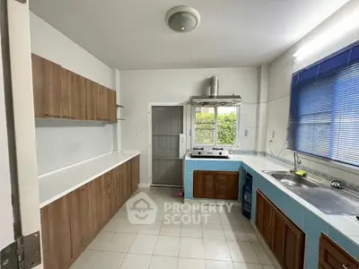 Spacious kitchen with modern cabinetry and ample natural light