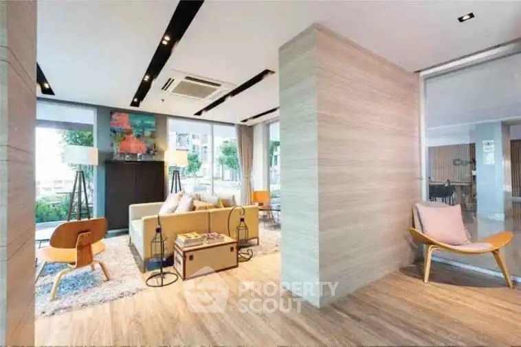 Spacious modern living room with stylish decor and large windows offering natural light.