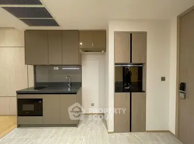 Modern kitchen with sleek cabinetry and built-in appliances in a stylish apartment.