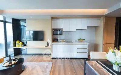 Modern open-layout kitchen and living room with sleek design and natural light