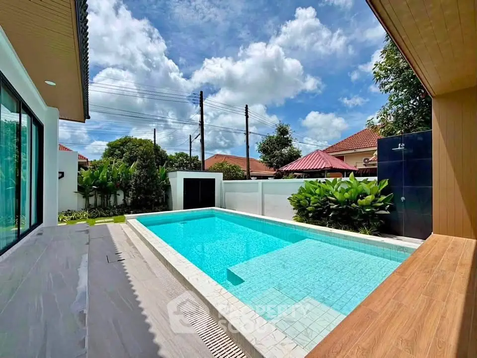 Luxurious private pool with modern design and lush greenery in a serene residential area.