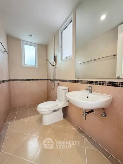 Spacious modern bathroom with sleek fixtures and natural light