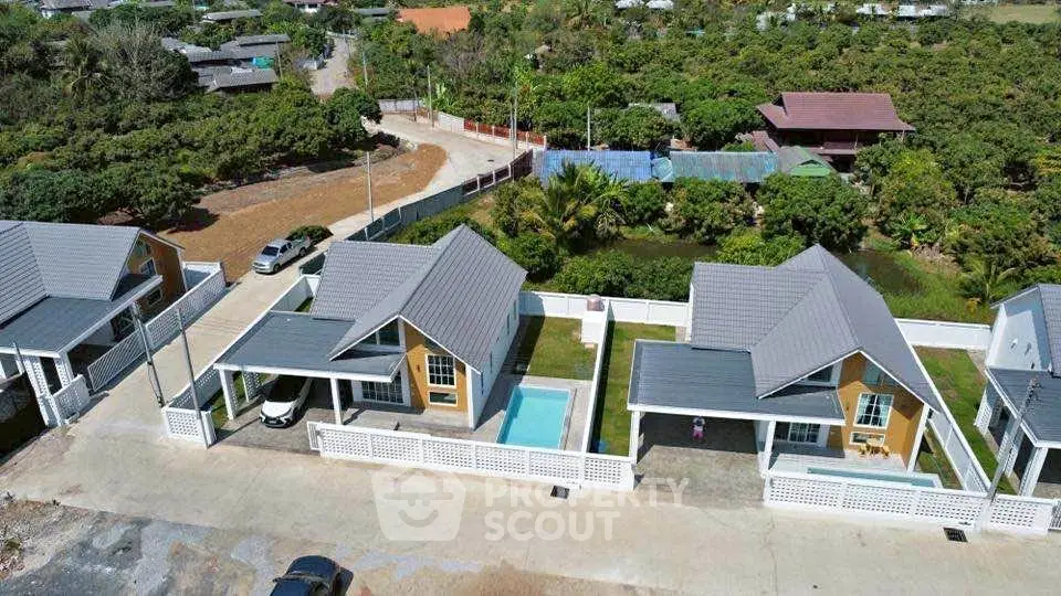 Charming suburban homes with private pools and modern design in lush green setting.