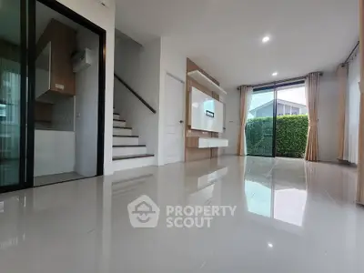 Spacious modern living room with sleek tile flooring and large windows for natural light.