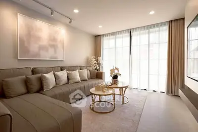 Elegant living room with modern decor and large windows