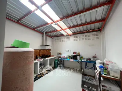 Spacious kitchen with open layout and ample storage space, featuring modern appliances and natural lighting.
