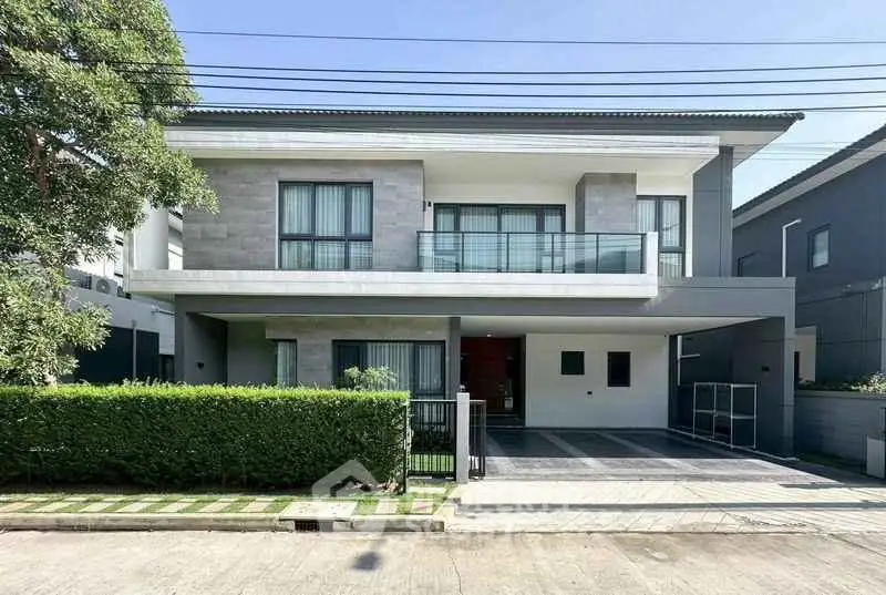 Modern two-story house with sleek design and spacious driveway in a serene neighborhood.