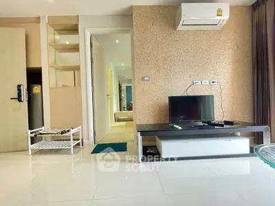 Modern living room with air conditioning and TV, featuring sleek design and bright lighting.