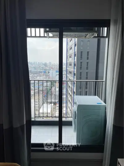 Modern high-rise balcony with city view and washing machine