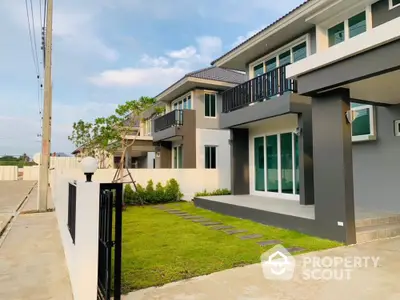 Modern townhouse with spacious front yard and sleek design in a serene neighborhood.