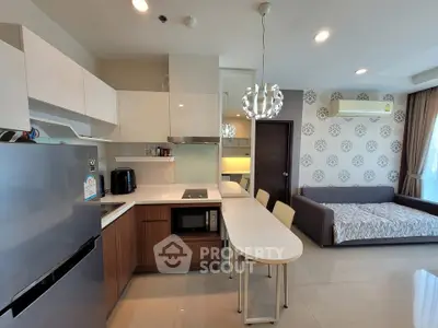 Modern open-plan kitchen and living area with stylish decor and natural light.