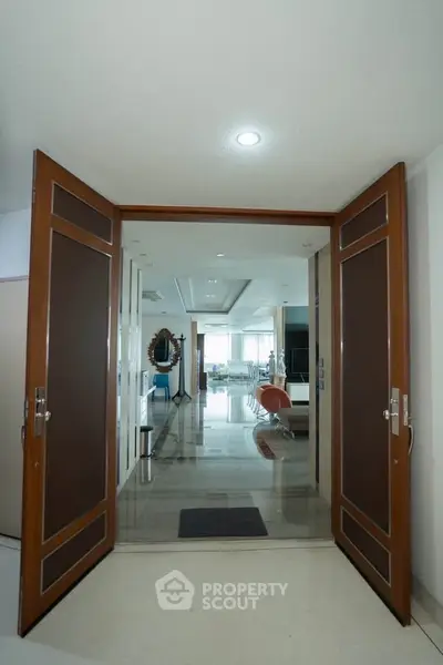 Spacious entrance leading to a luxurious living area with modern decor and ample natural light.