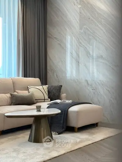 Luxurious living room with elegant marble wall and cozy sofa, perfect for relaxation.