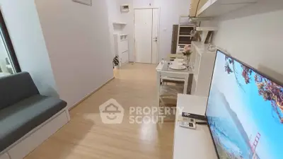 Modern living room with sleek TV setup and cozy dining area