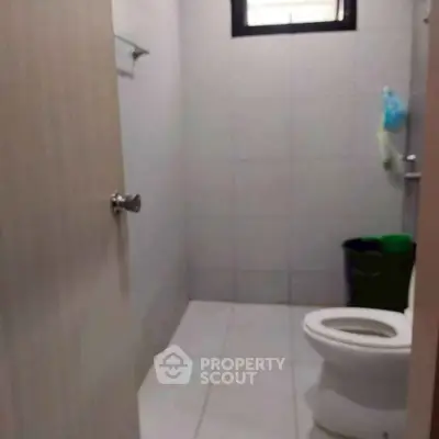 Compact bathroom with modern fixtures and tiled walls