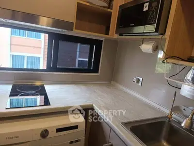 Modern kitchen with sleek appliances and compact design