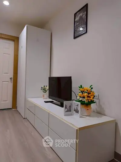 Modern living room with sleek TV stand and vibrant floral decor