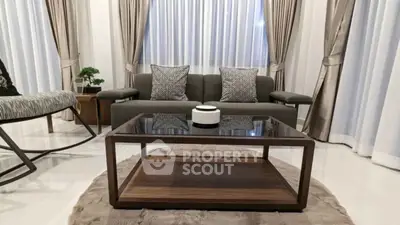 Elegant living room with modern furniture and stylish decor, featuring a cozy seating area and chic coffee table.