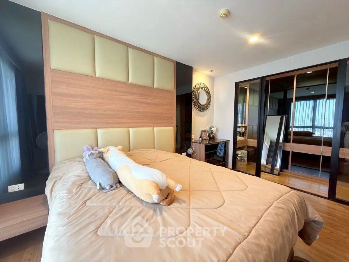 Spacious bedroom with modern decor and large mirrored wardrobe