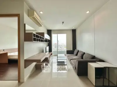 Modern living room with sleek furniture and city view, perfect for urban living.