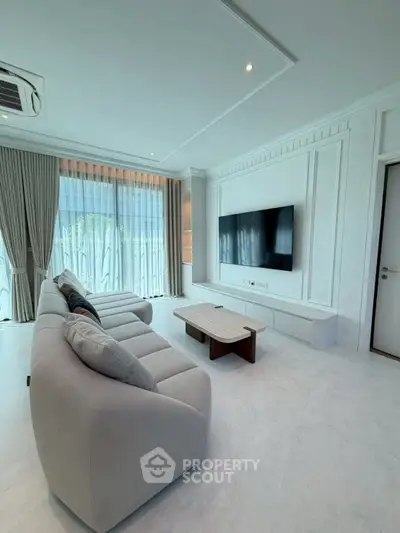 Spacious modern living room with large TV and elegant decor