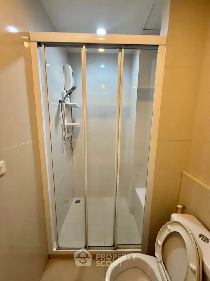 Modern bathroom with glass shower enclosure and sleek fixtures