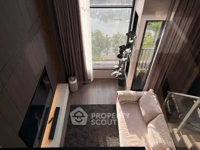 Luxurious living room with high ceiling and stunning view from large windows.