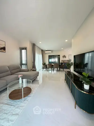 Spacious modern living room with elegant decor and large TV