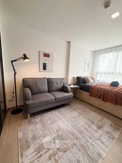 Modern studio apartment with cozy living area and stylish decor