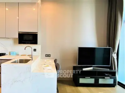 Modern kitchen and living area with sleek design and natural light