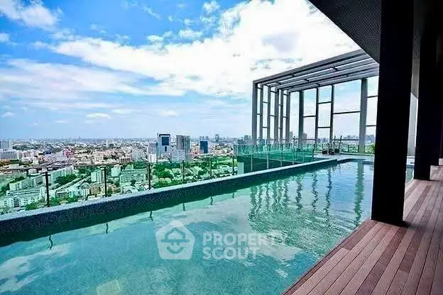 Luxurious rooftop pool with stunning city skyline view, perfect for relaxation and leisure.