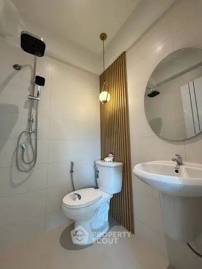 Modern bathroom with sleek fixtures and stylish lighting in a contemporary apartment.