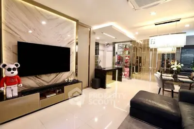 Luxurious modern living room with marble accent wall and elegant lighting