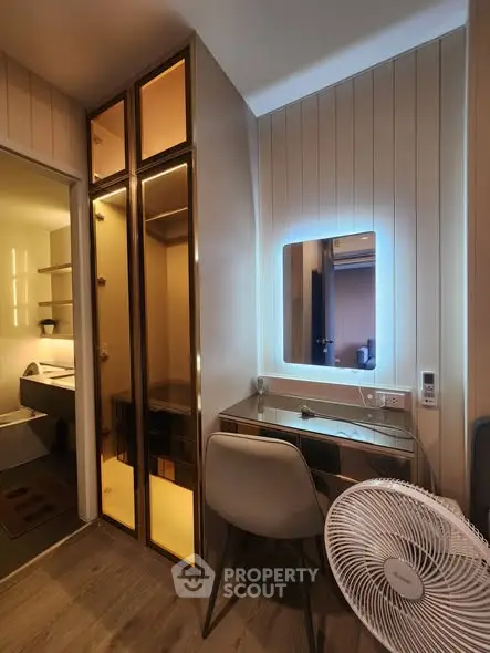 Modern study nook with illuminated mirror and sleek storage in cozy apartment