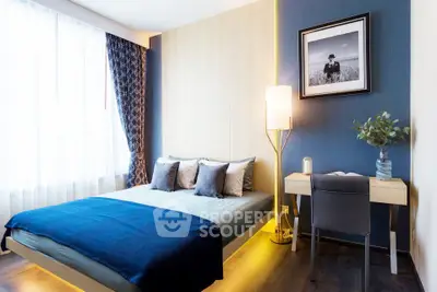 Modern bedroom with stylish decor, featuring a cozy bed, elegant lighting, and a chic desk area.